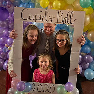 four people at the cupids ball photo station