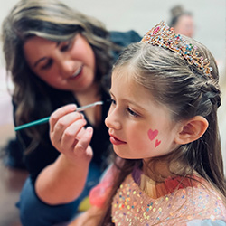 a girl getting her face painted